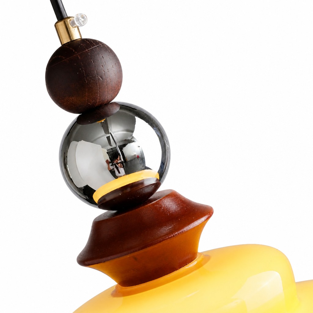 Close-up of cord, wooden sphere, and reflective glass